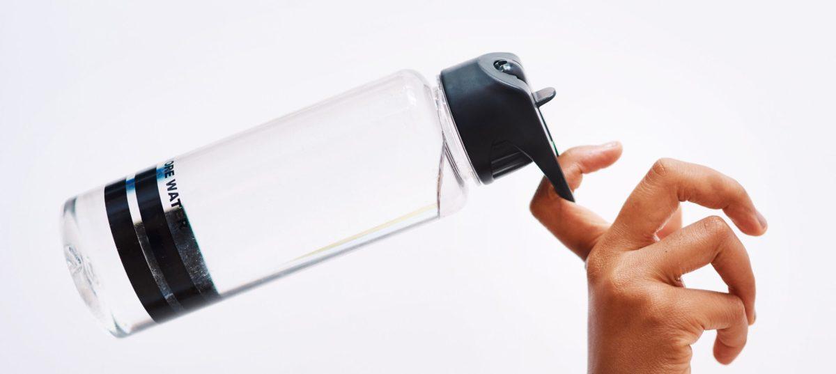 Studio shot of an unrecognizable woman holding a water bottle against a white background