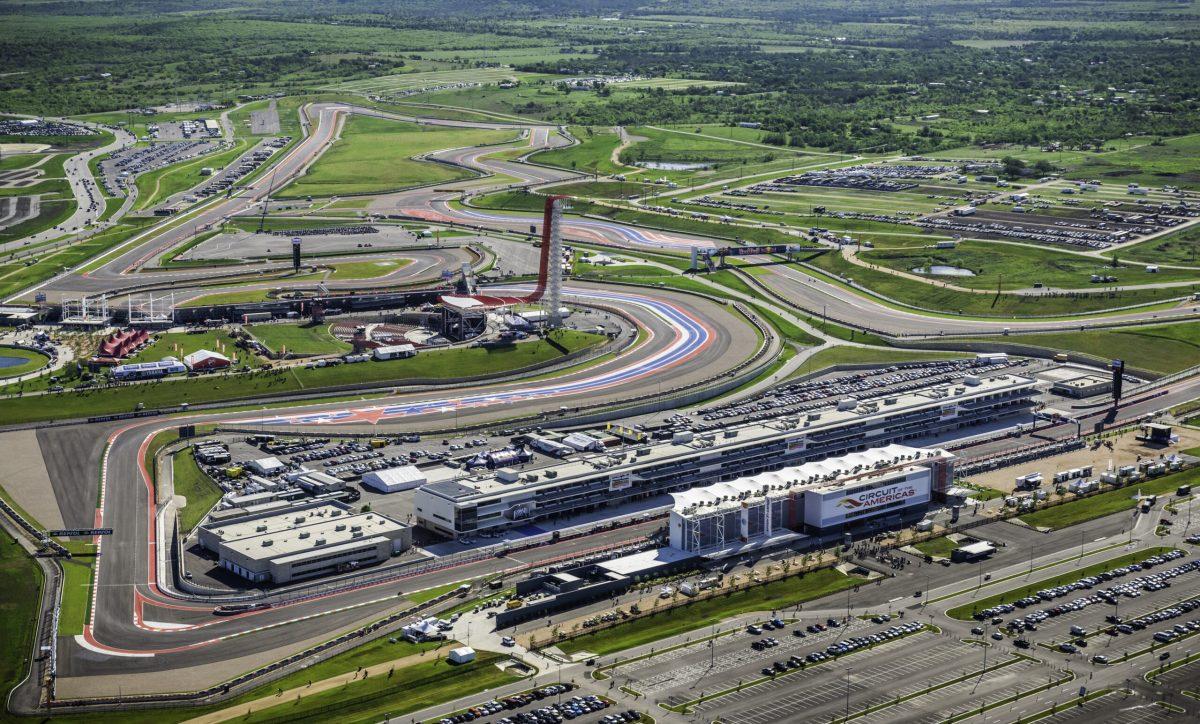 Austin, Texas, USA - April 19, 2013: Austin area aerial from helicopter withCircuit of the AmericasaA motorsports race track in foreground. MotoGPaA - Motorcycle Racing World Championship, free practice 1 in session.